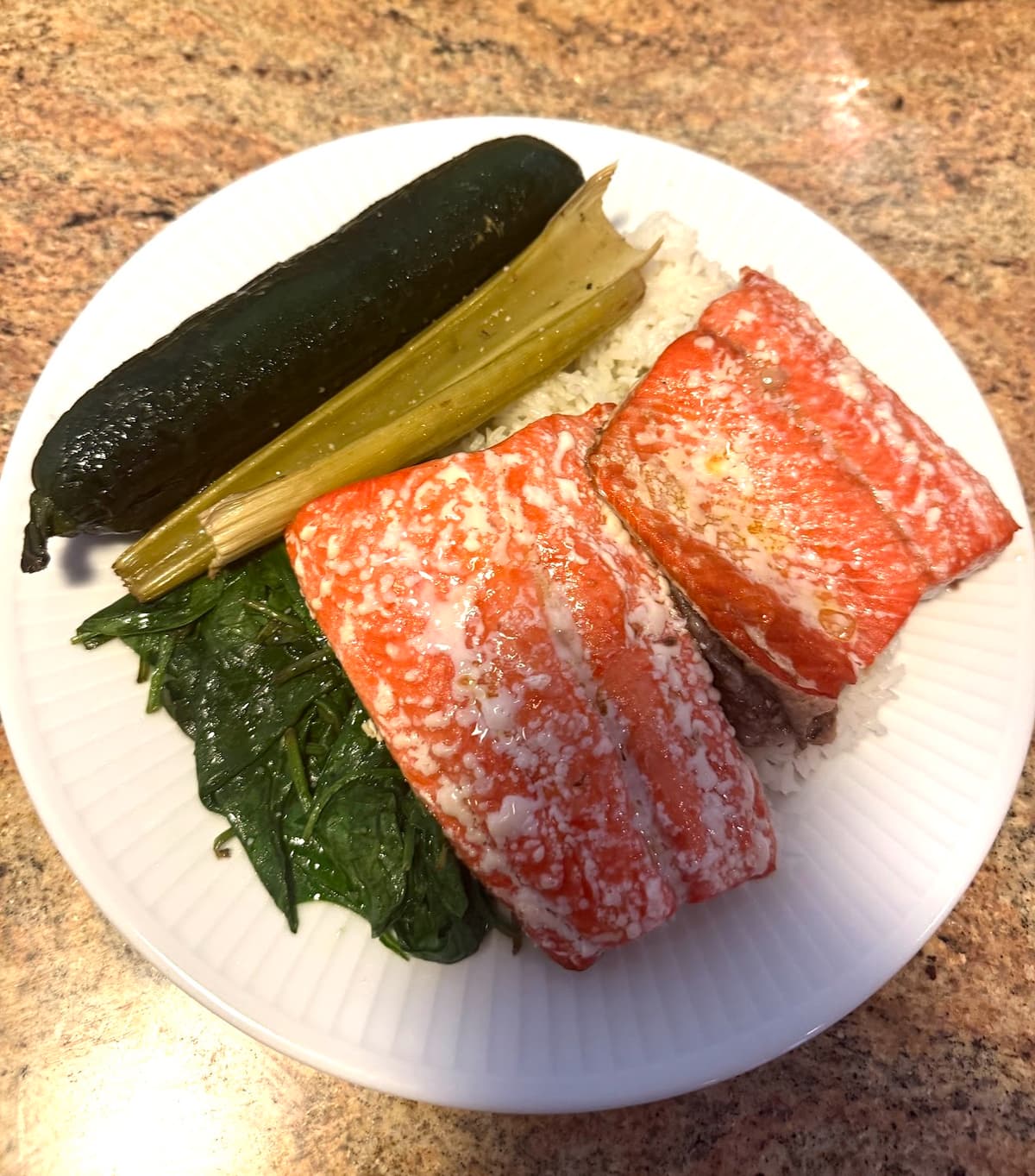 A typical daily serving: two pieces of wild sockeye salmon over rice with sautéed spinach